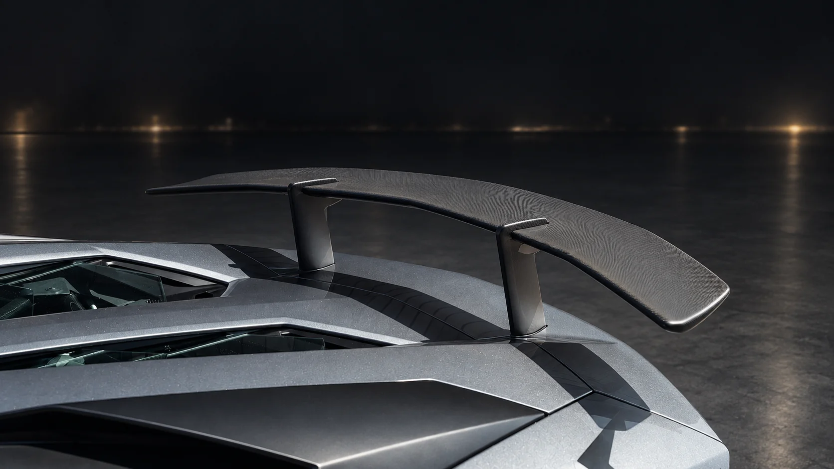 Aventador SV Roadster head-on at dusk, roof off, headlights lit