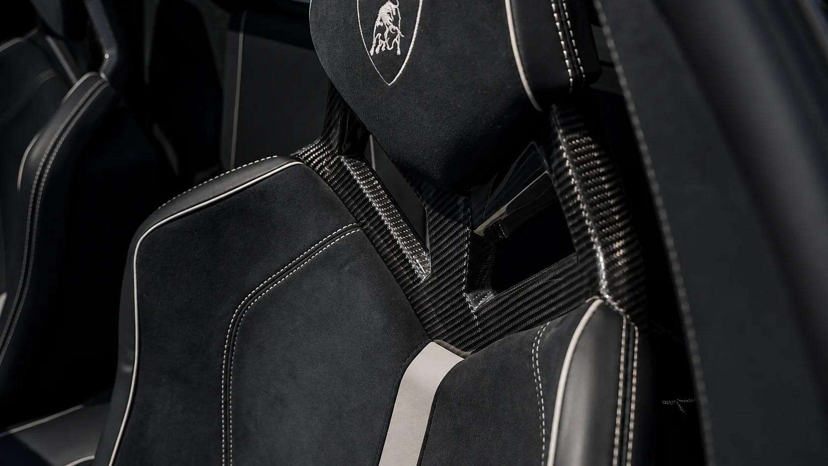 Sport seats — exposed carbon shells, Alcantara upholstery and Grigio Cronus stitching
